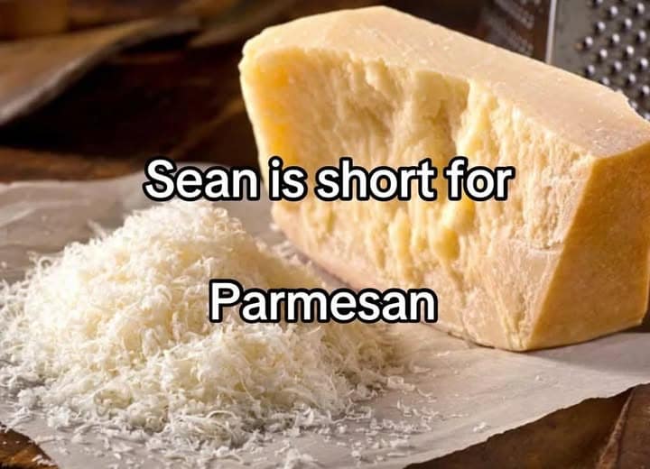 A classic meme featuring a wedge of parmesan cheese next to a pile of grated cheese. The text overlay delivers a nonsensical, phonetic pun: "Sean is short for Parmesan."