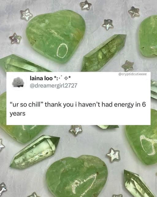 A classic meme tweet from @dreamergirl2727 superimposed over a vibrant background of green heart-shaped and crystalline stones. The text reads: "'ur so chill' thank you i haven't had energy in 6 years," perfectly summarizing the "burnout aesthetic."