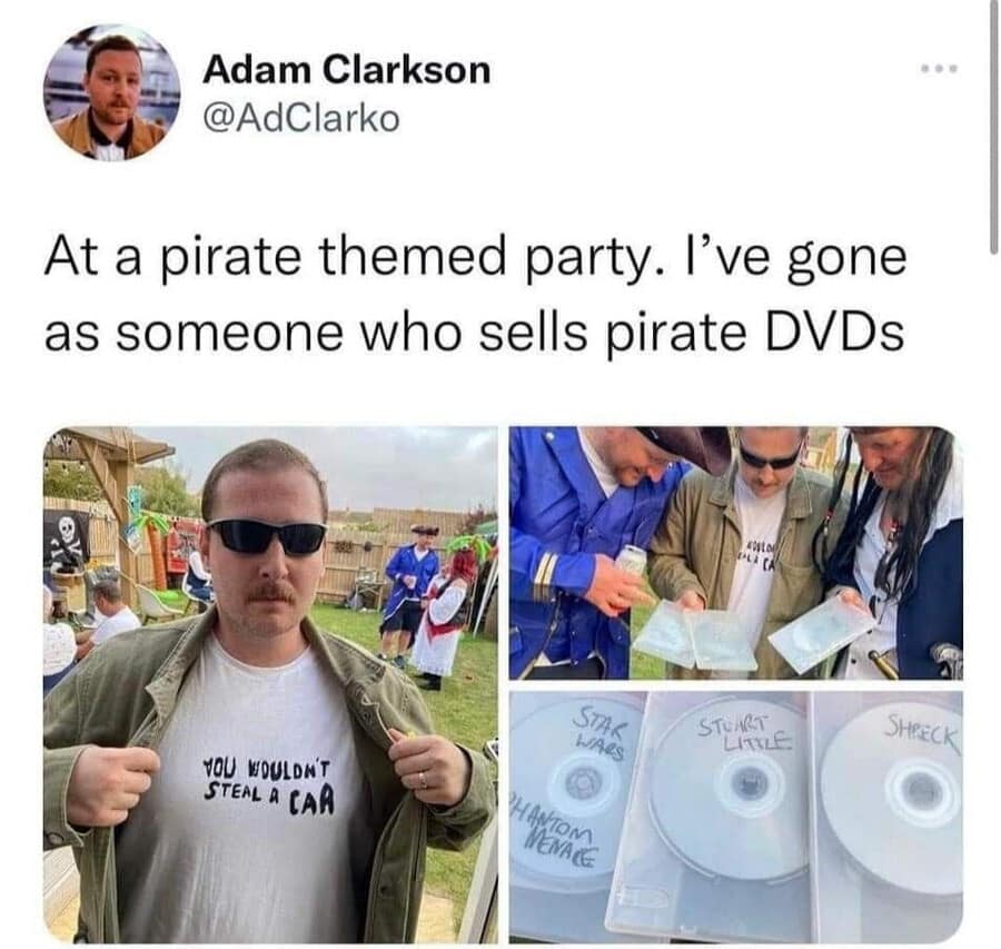 A meta classic meme showing Adam Clarkson at a pirate-themed party. Instead of a buccaneer, he's dressed as a "bootleg DVD seller," wearing an olive jacket over a "YOU WOULDN'T STEAL A CAR" anti-piracy shirt while holding DVDs labeled "Shreck" and "Star Wars."