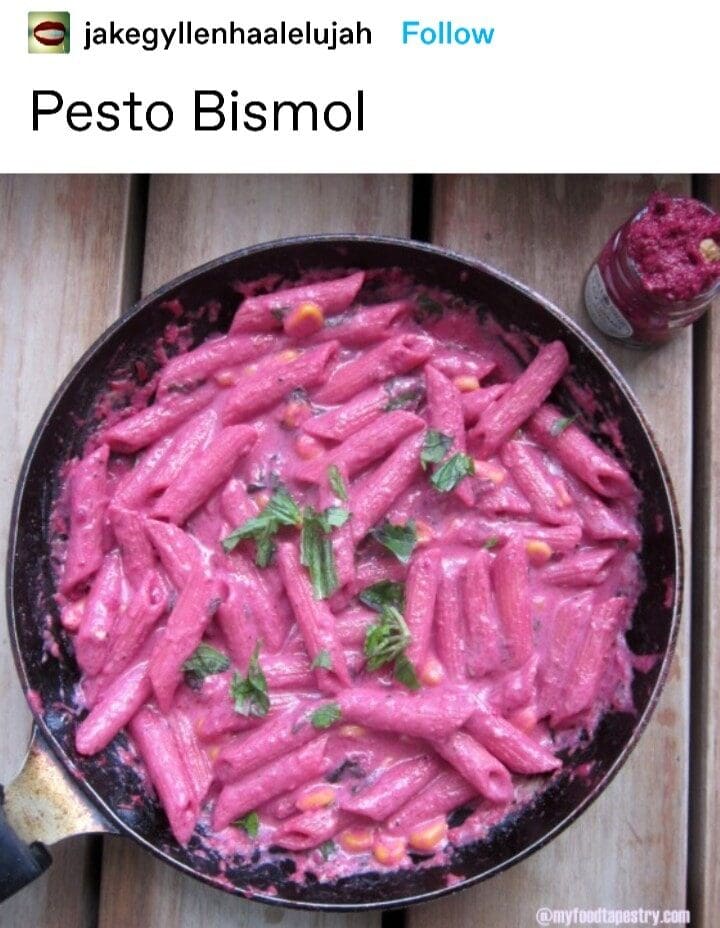 cursed food classic meme showing a skillet filled with penne pasta drenched in an uncomfortably vibrant, opaque pink sauce. The caption reads "Pesto Bismol," punning on the digestive medicine Pepto-Bismol.