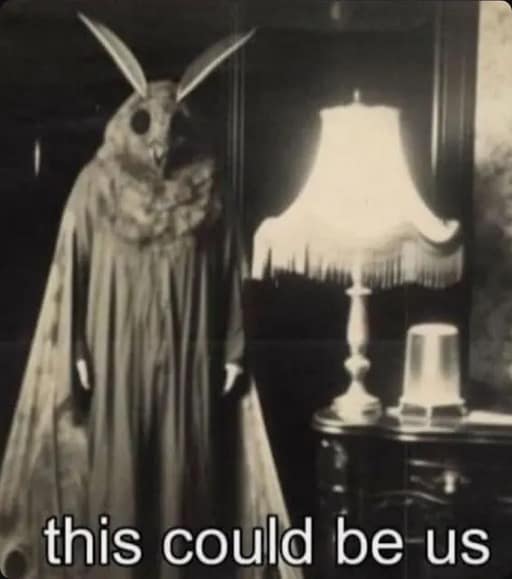 A spooky black-and-white classic meme showing a person in a Mothman-like costume with large black eyes and long antennae standing in a dimly lit room next to a fringed vintage lamp. The caption reads: "this could be us."