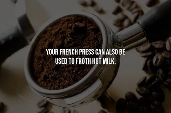 Espresso portafilter packed with fresh coffee grounds beside scattered beans, illustrating coffee hacks for home brewing.