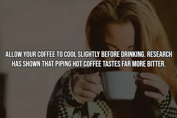 Woman in cozy sweater holding large white mug close to her face, demonstrating cooler coffee taste hack.