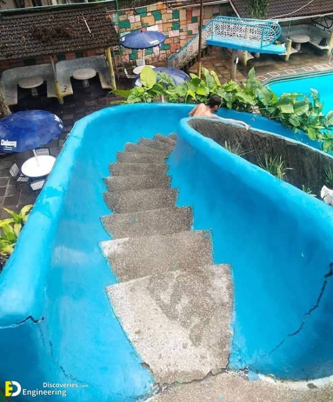 Water slide built with concrete steps down the middle rendering it completely unusable for sliding