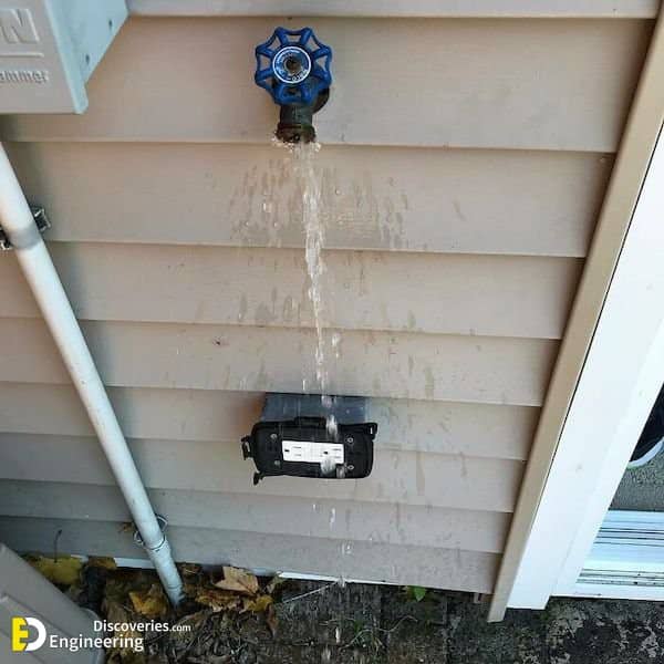 Outdoor water spigot installed directly above exterior electrical outlet creating dangerous water-over-electricity hazard