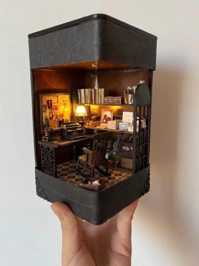 Vintage writer's retreat cool bookends depicting a cozy room with a miniature typewriter, a wooden rocking chair, and warm ambient lighting reflecting off tiny book spines.