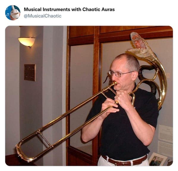 A terrifying cursed instrument modification featuring a trombone. The standard brass bell has been replaced with a massive, realistic rattlesnake head, fangs bared and mouth wide open, giving the impression that the music is being hissed directly at the audience.