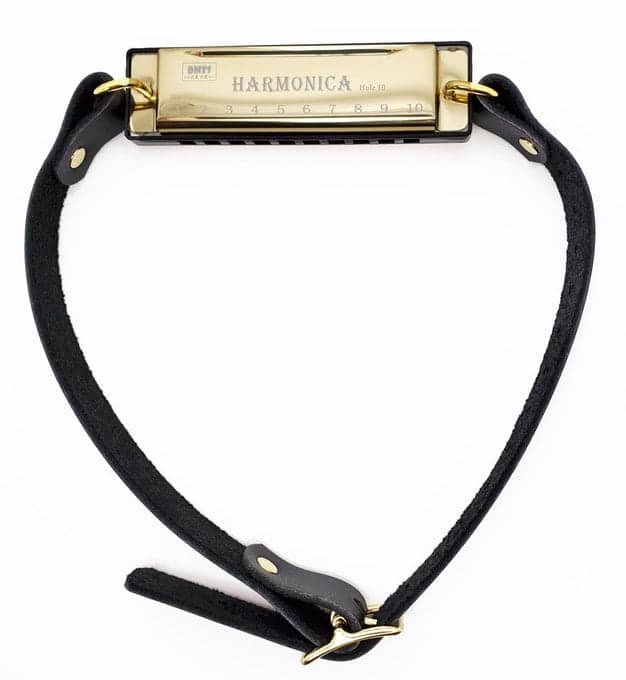 A bizarre cursed instrument featuring a high-polish gold harmonica integrated into a black leather collar with a buckle. Designed to be worn around the neck, it suggests a hands-free musical experience that is as fashionable as it is likely to cause a noise complaint.