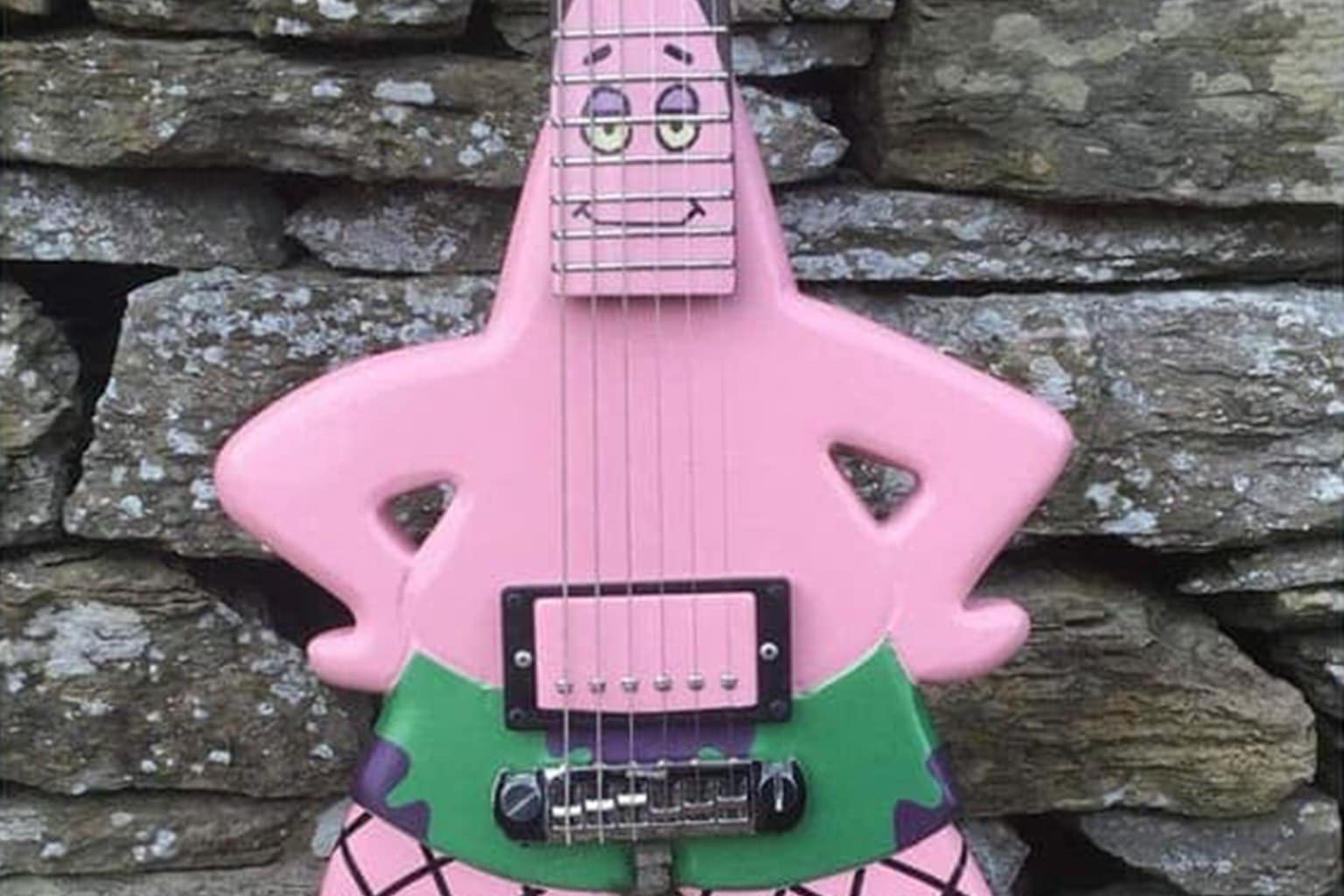 A dump of cursed instruments featuring a violin equipped with a sniper scope and bayonet, a person wearing a full suit of armor made entirely out of tubas, and a guitar constructed from a real human ribcage and spine.