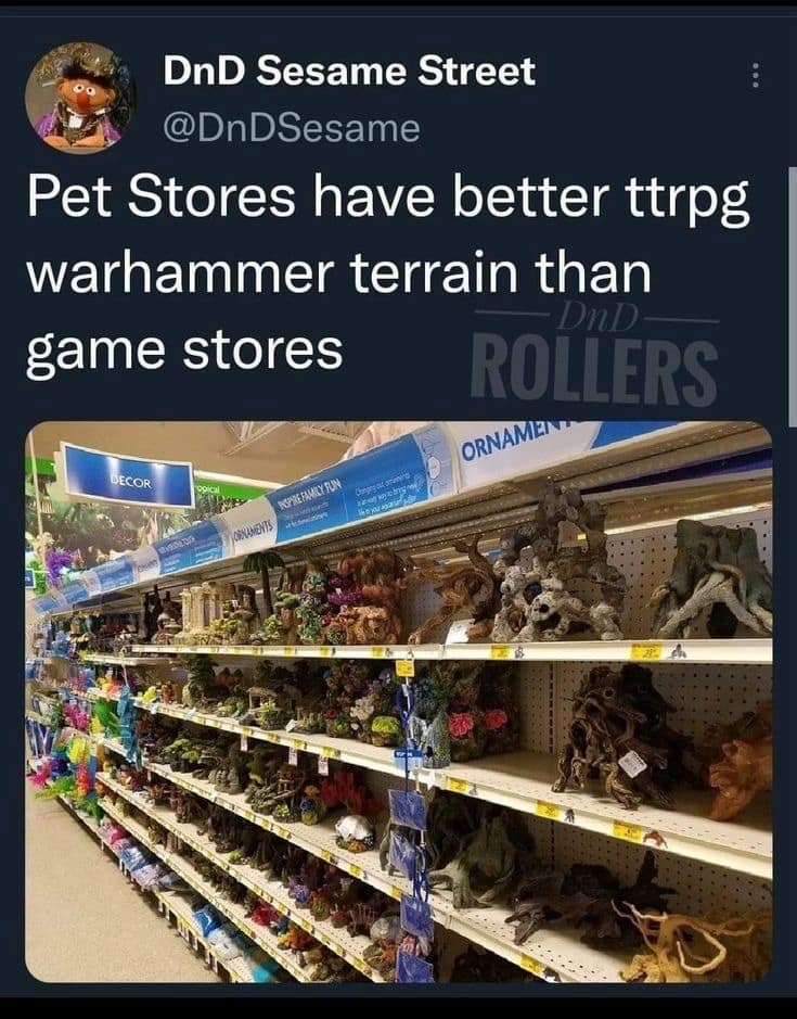 A practical "life hack" d&d meme showing a photo of an aquarium decoration aisle in a pet store. The text observes that pet stores often have better and more affordable TTRPG and Warhammer terrain than actual hobby stores.