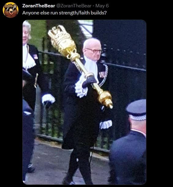 A real-life d&d meme featuring a photo of a man in traditional British ceremonial court attire, including a ruffed collar and black robes. He carries a massive, ornate golden mace over his shoulder, captioned: "Anyone else run strength/faith builds?"