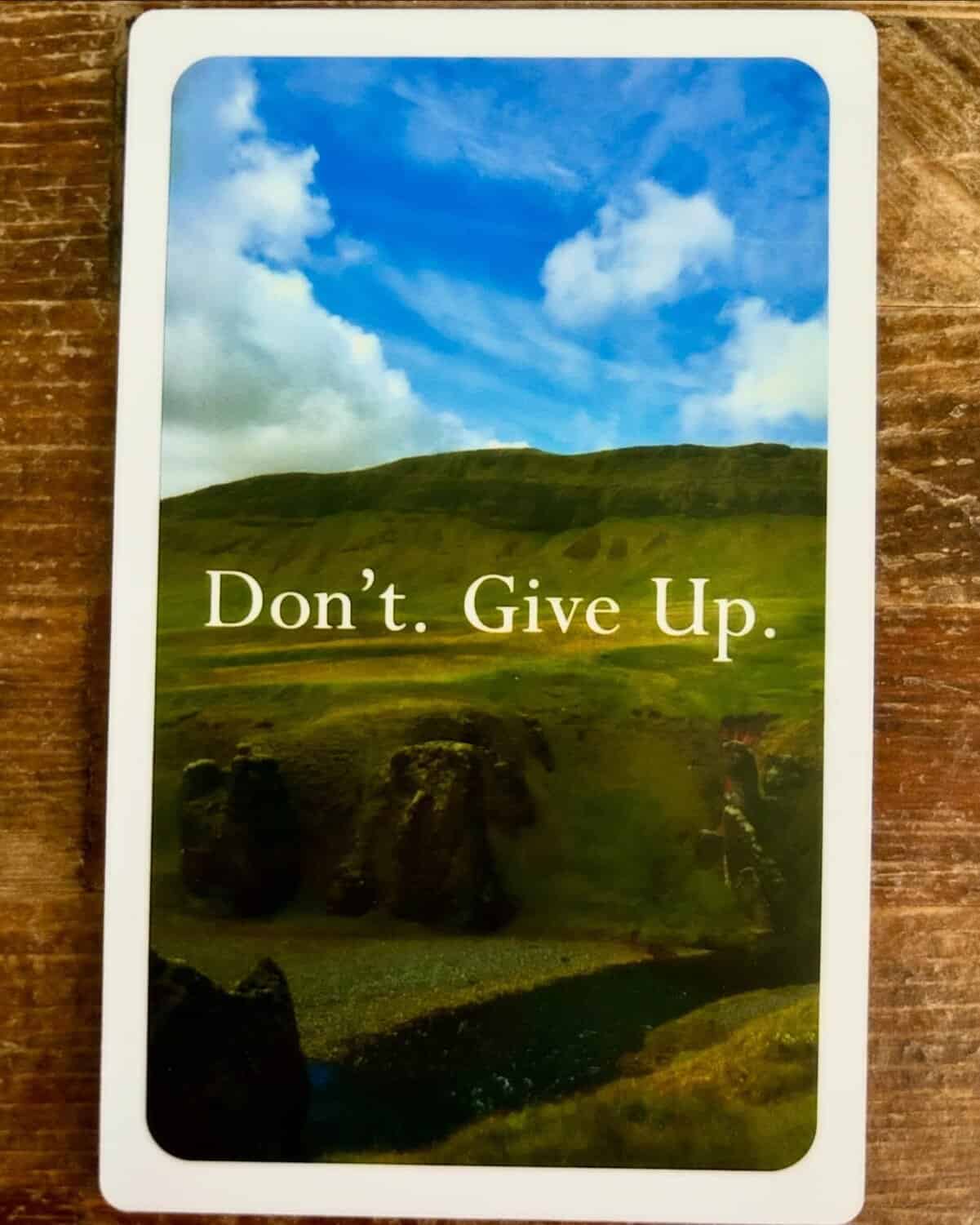 Demotivational quote card showing toppled Moai statues sternly commanding readers simply not to give up.