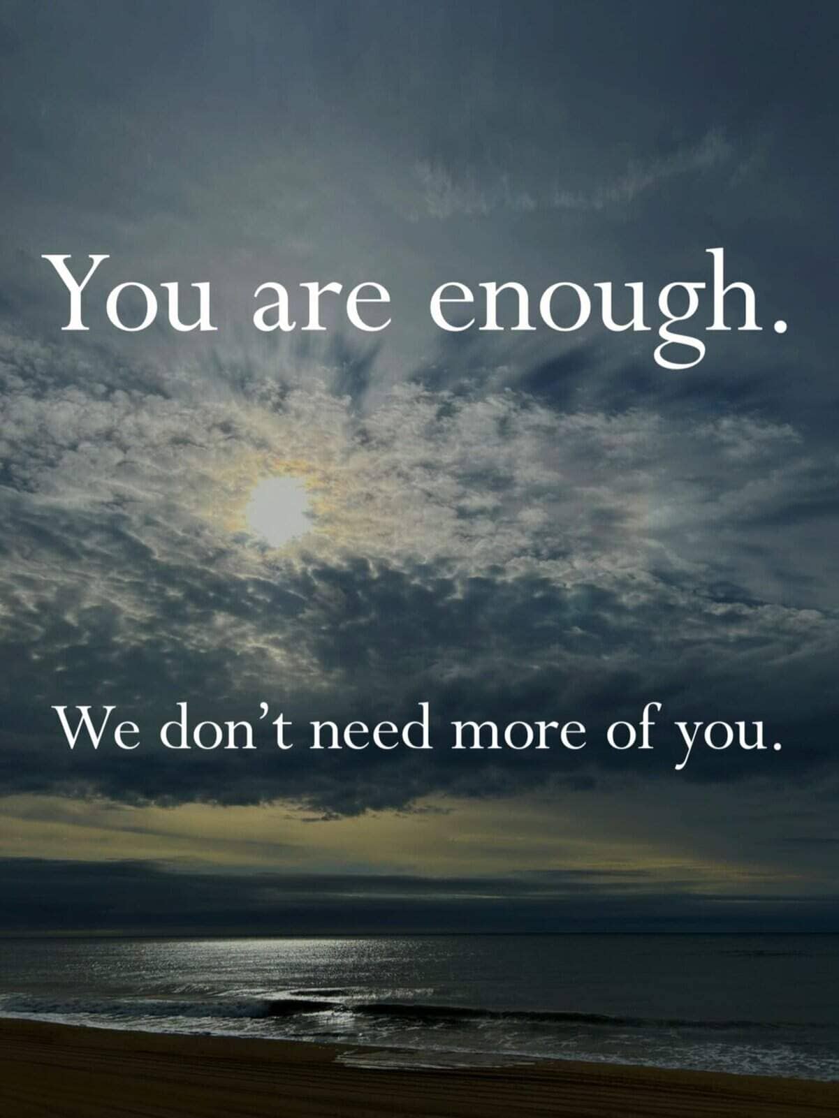 Demotivational quote over cloudy beach sky bluntly assuring readers we truly don't need more of them.