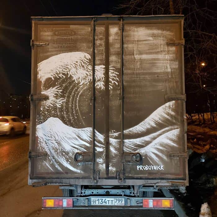 Detailed replica of The Great Wave off Kanagawa created using dirt on a vehicle.