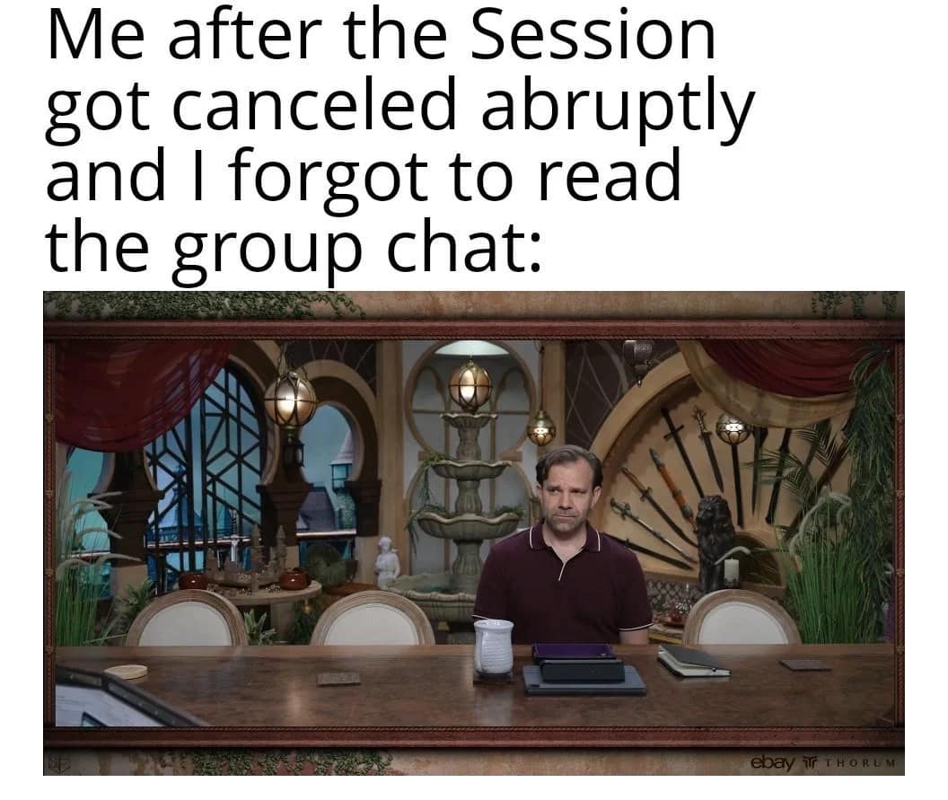 A relatable d&d meme featuring Sam Riegel from Critical Role sitting with a dejected expression at a massive, empty gaming table. The text reads: "Me after the Session got canceled abruptly and I forgot to read the group chat."