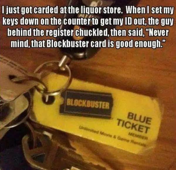 A nostalgic dumb meme showing a set of car keys with a vintage, bright yellow Blockbuster "Blue Ticket" member keychain. The text describes a liquor store clerk accepting the defunct rental card as proof of age, reasoning that "no young person would have this."