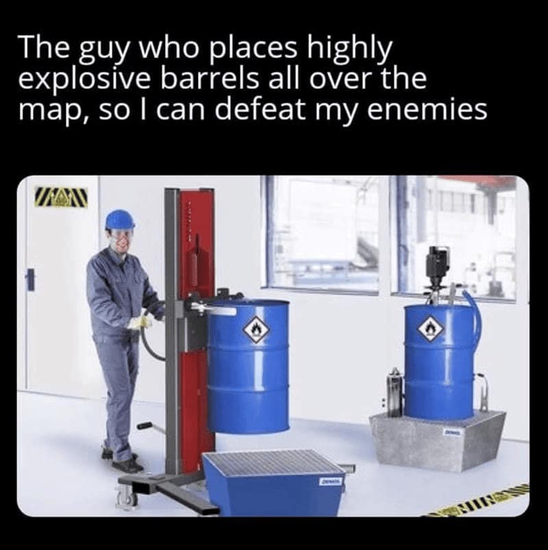 logical funny rpg meme showing a stock photo of a smiling warehouse worker moving industrial blue barrels with a forklift. The text celebrates: "The guy who places highly explosive barrels all over the map, so I can defeat my enemies," acknowledging the convenient placement of "red barrel" tropes.