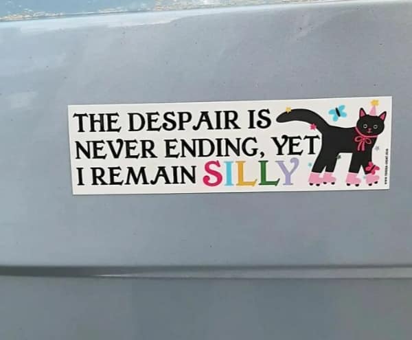 A funny bumper sticker on a silver car bumper that simply states MY OTHER VEHICLE IS MY MIND in clean, black capital letters on a white rectangular background.