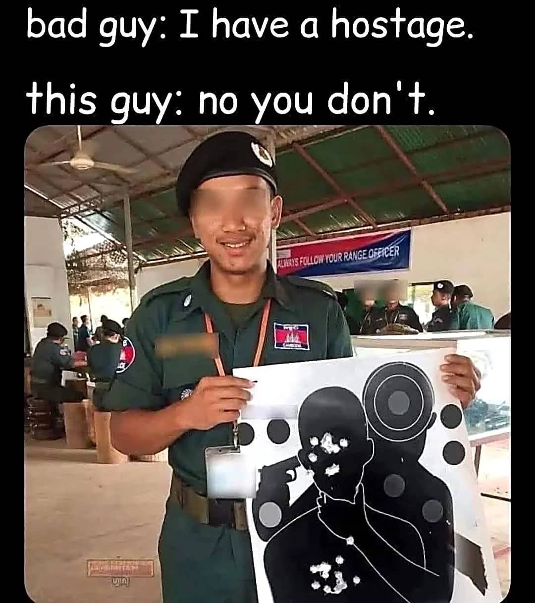 Soldier holding a paper shooting target with bullet holes concentrated on the hostage figure's face.