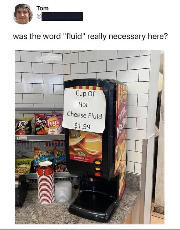 A photo of a nacho cheese dispenser labeled Cup of Hot Cheese Fluid for two dollars.