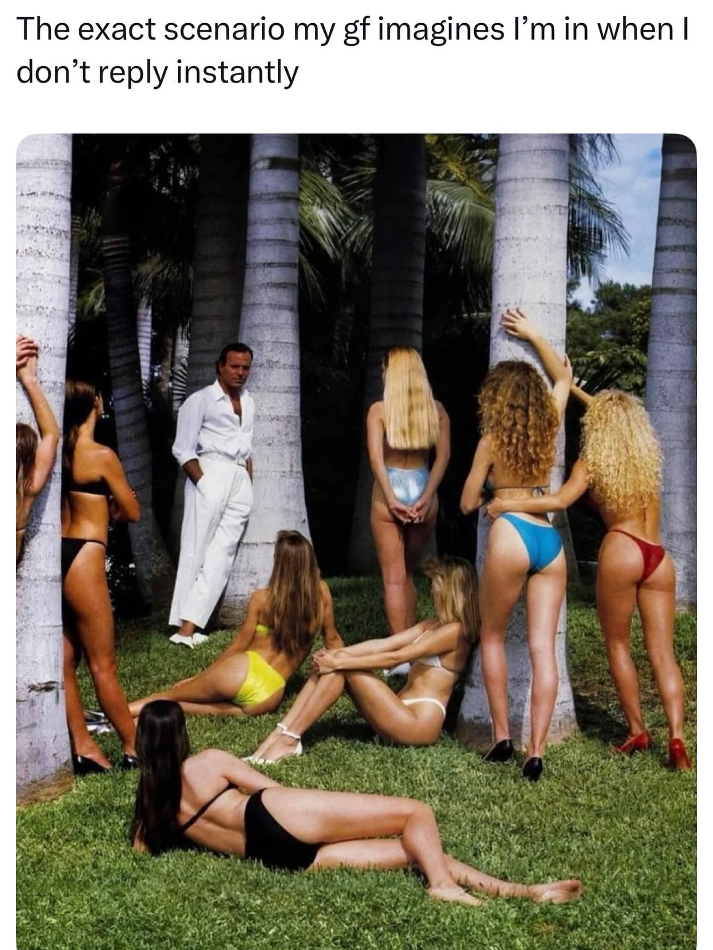 Man in white standing in a tropical garden surrounded by women in swimsuits with funny text.