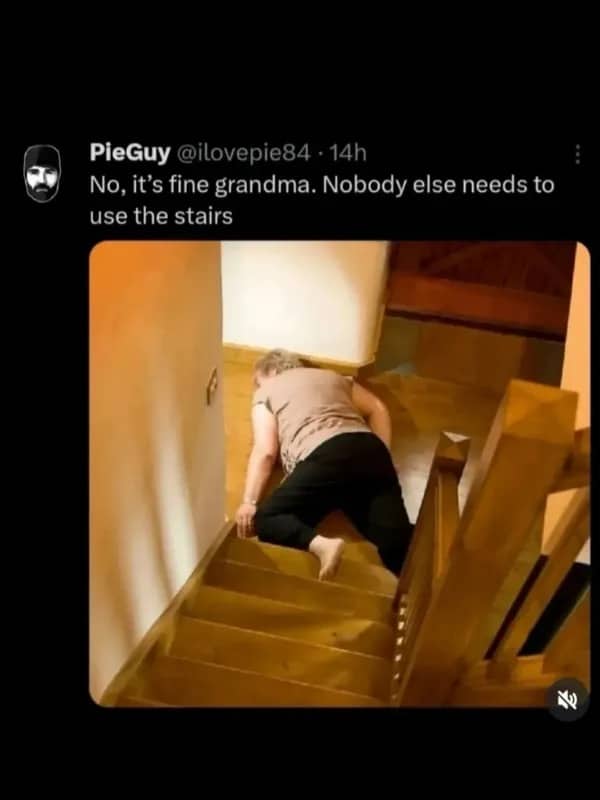 Funny social media post showing a grandmother lying across wooden stairs and blocking the path.