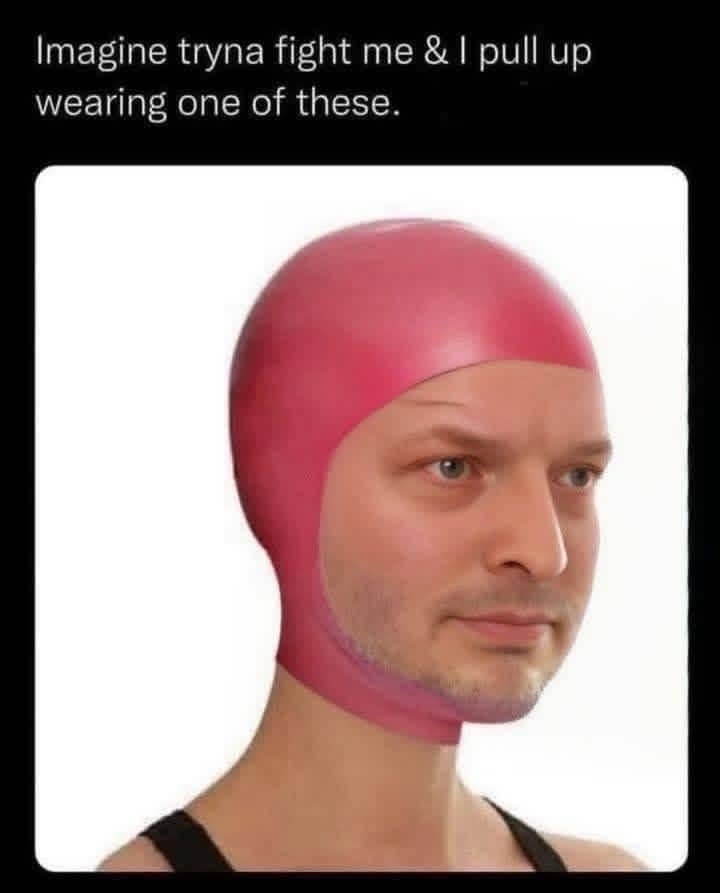 Man wearing a tight pink rubber swim cap with a caption about someone trying to fight him.