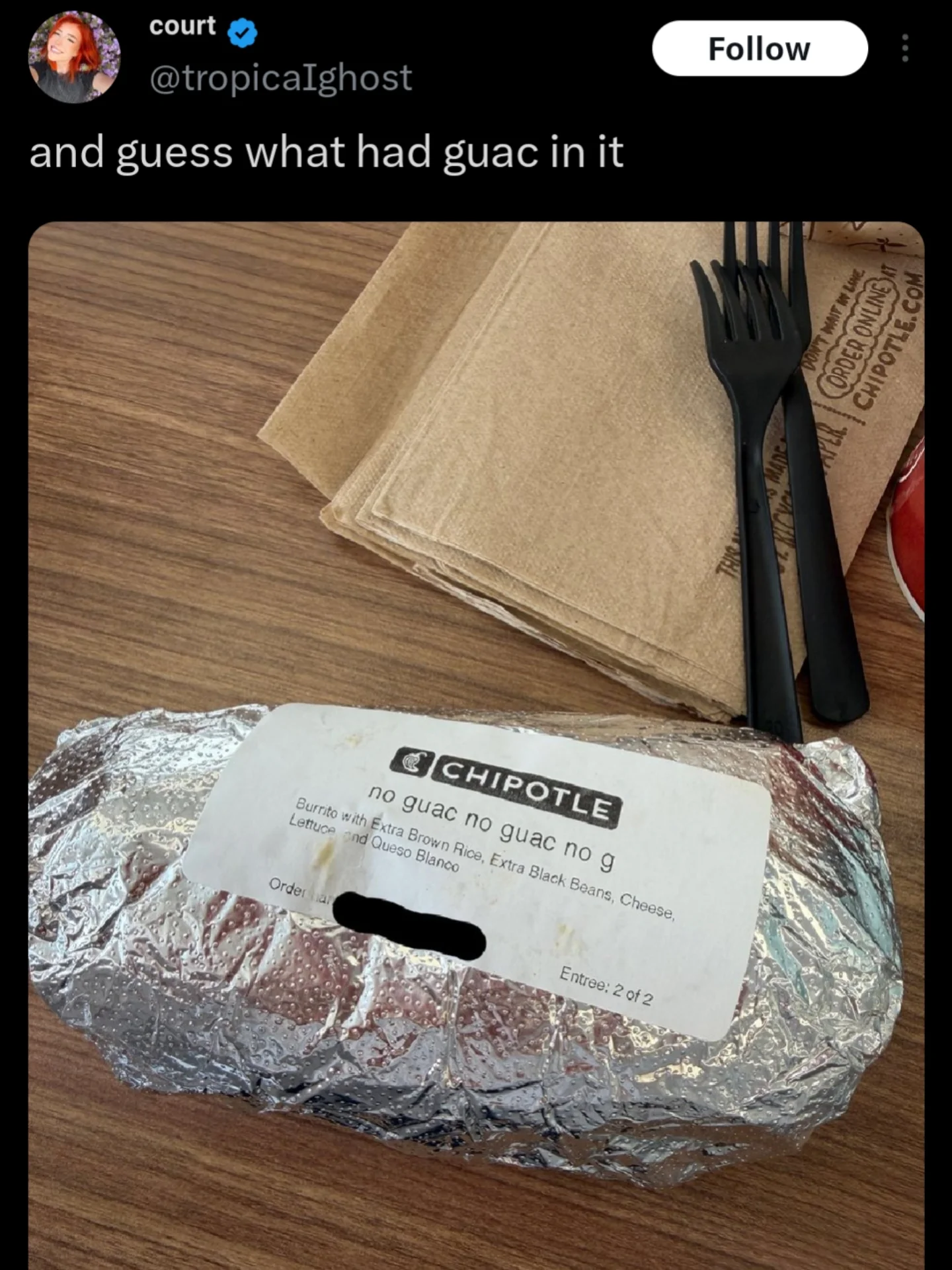 Funny photo of a Chipotle burrito labeled no guac multiple times but still containing guacamole.