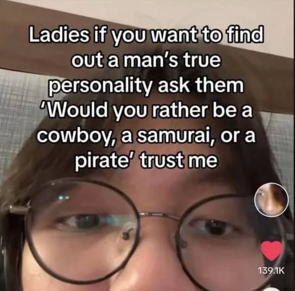 A close-up of a person with glasses giving dating advice about asking men their warrior preference.