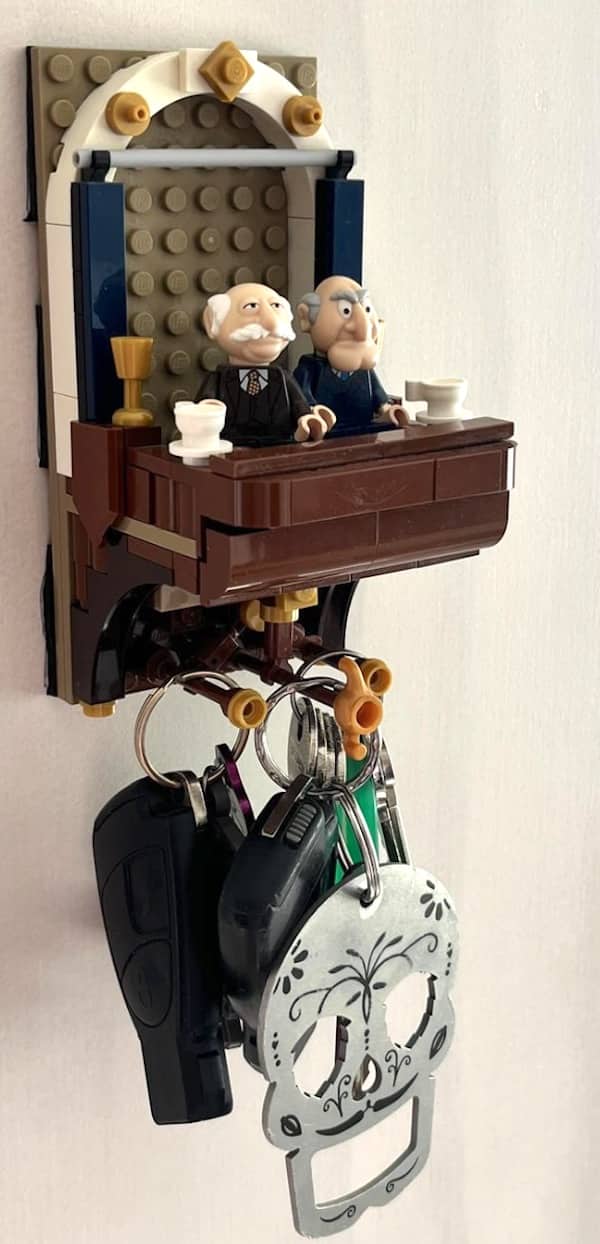 Lego key holder designed as the Muppets Statler and Waldorf on a balcony with keys hanging below.