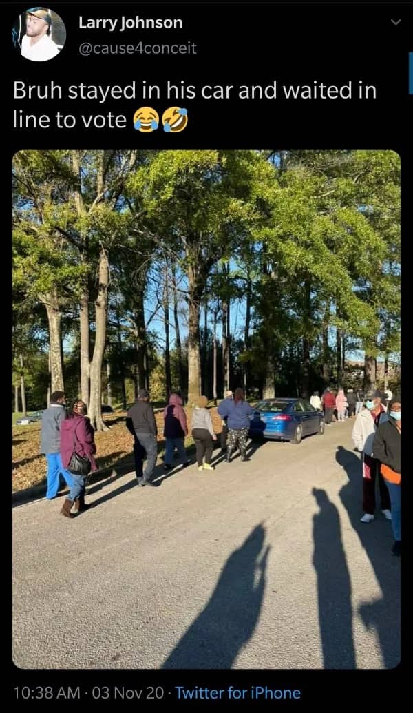 Funny photo of a blue car waiting in a walking line of people at a polling place.