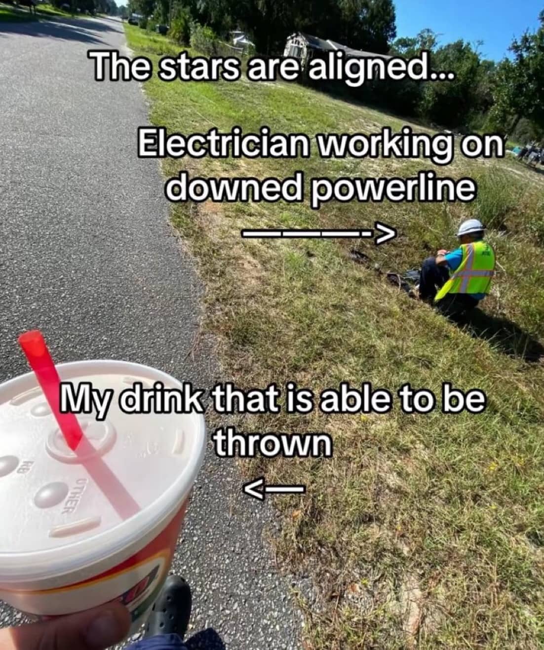 First-person view holding a large drink next to an electrician working on a downed powerline.