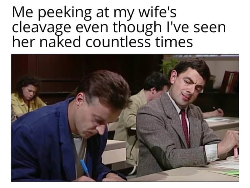 A funny relatable meme utilizing the classic Mr. Bean scene where he shamelessly cheats during an exam. The text compares his sneaky side-eye to a husband peeking at his wife’s cleavage, despite having seen her fully naked thousands of times.