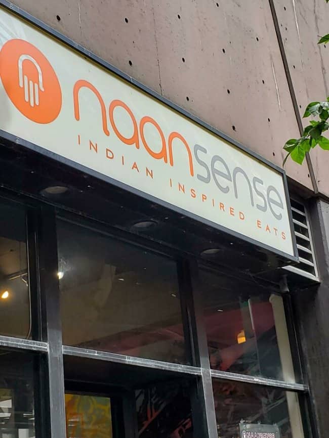 Naansense Indian Inspired Eats storefront with bright orange logo, a clever pun on a beloved flatbread.