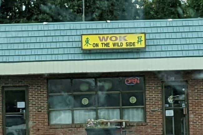 Wok on the Wild Side Chinese restaurant with brick exterior and yellow signage, Lou Reed inspired pun.