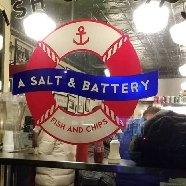 A Salt & Battery fish and chips shop with nautical life preserver signage and clever assault pun.