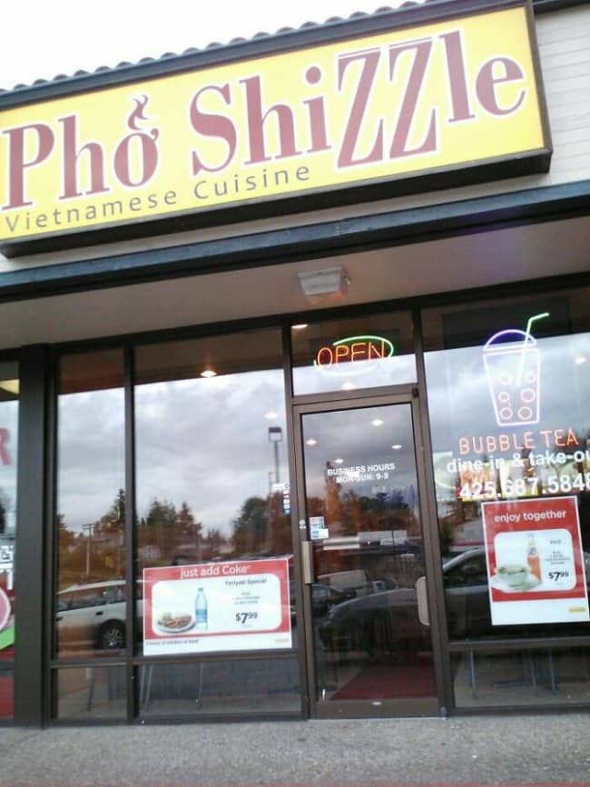 Pho Shizzle Vietnamese restaurant storefront with bold yellow signage and bubble tea advertisement.