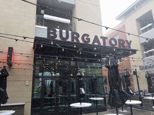 Burgatory restaurant entrance in snowy weather, modern signage punning on the afterlife waiting room.