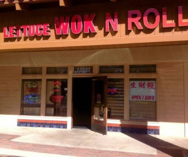 Lettuce Wok N Roll Chinese restaurant exterior with red signage and bilingual storefront, clever rock pun.
