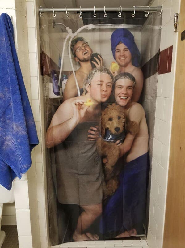 funny shower curtain featuring a group of four men and a fluffy golden retriever posing for a playful, towel-clad group photo. The curtain itself is a printed replica of the photo, creating a bizarrely meta and hilarious bathroom atmosphere.