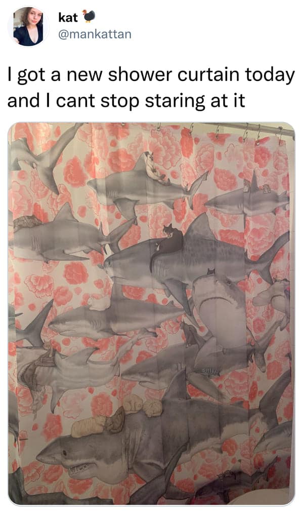 A dense and chaotic funny shower curtain with a floral pink background. Over the roses, dozens of realistic great white sharks are swimming in every direction, each carrying a different cat or kitten on its back as a feline rider.