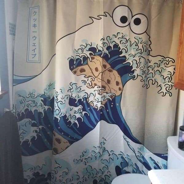 An artistic funny shower curtain that mashes up pop culture and classic Japanese art. It depicts Cookie Monster as the crashing "Great Wave off Kanagawa," where the white foam of the wave is composed of dozens of chocolate chip cookies.