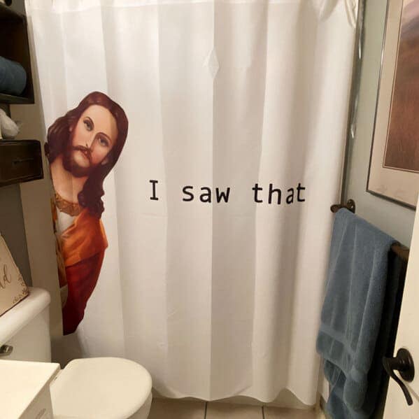 A minimalist funny shower curtain showing a traditional illustration of Jesus Christ peeking around the left edge of the white fabric. In the center, the simple, accusatory text reads: "I saw that."