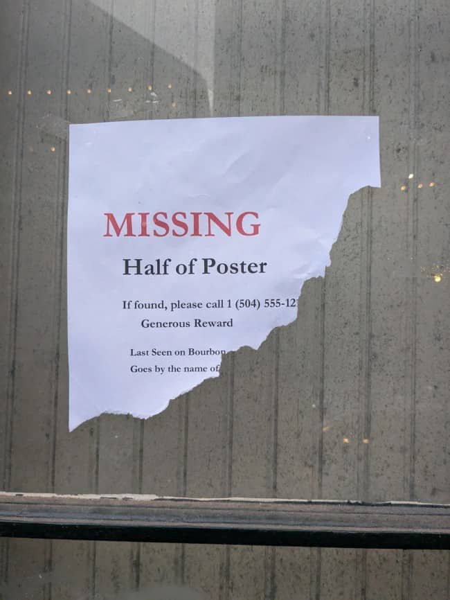 Self-referential missing poster with half torn away reporting itself as the missing item with reward offered
