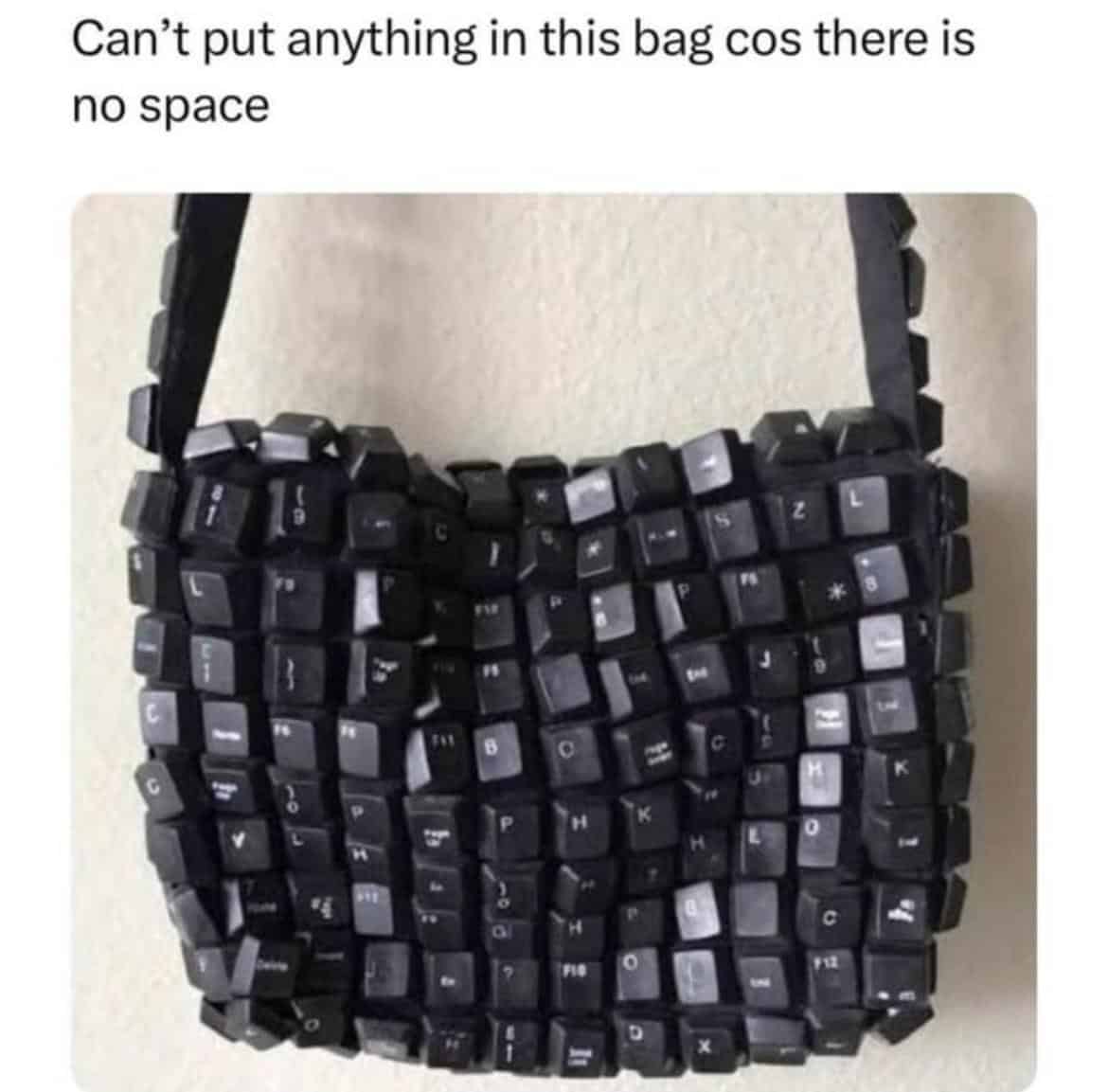 Handmade purse constructed entirely from black keyboard keys captioned there is no space bar pun