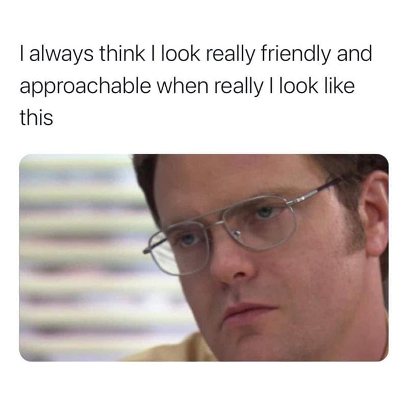 adulting meme featuring a close-up of Dwight Schrute from The Office with a stern, judgmental expression. The text above says, "I always think I look really friendly and approachable when really I look like this."