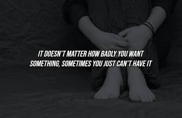 Person sitting alone hugging knees with hard truth quote about not always getting what you desperately want