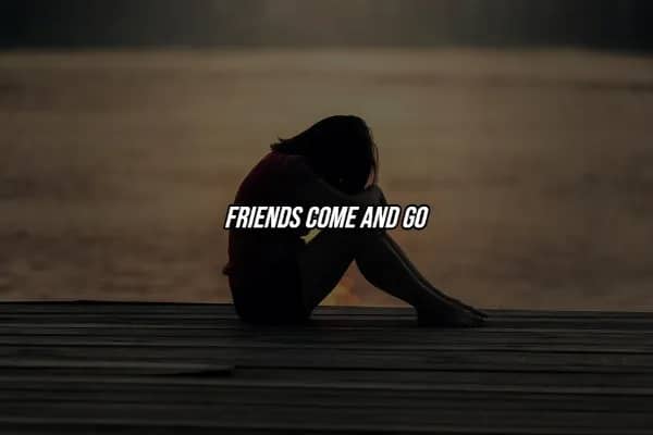 Lone silhouette sitting on dark dock with simple hard life lesson quote reminding us friends come and go