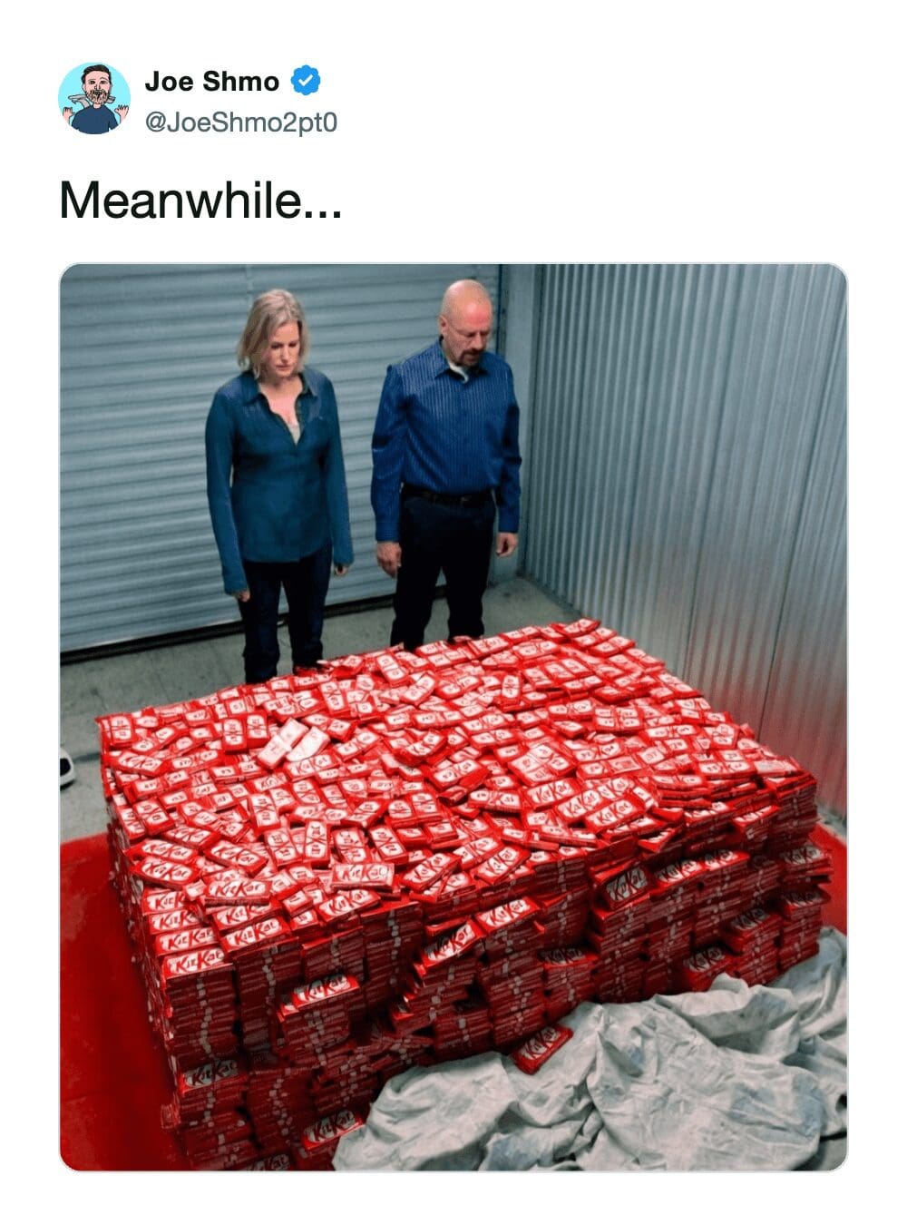 high-production KitKat heist meme from Joe Shmo. It uses the iconic "storage unit" scene from Breaking Bad, showing Walter and Skyler White staring in disbelief at a massive, floor-to-ceiling pile of red KitKat boxes instead of cash. The caption reads, "Meanwhile..."