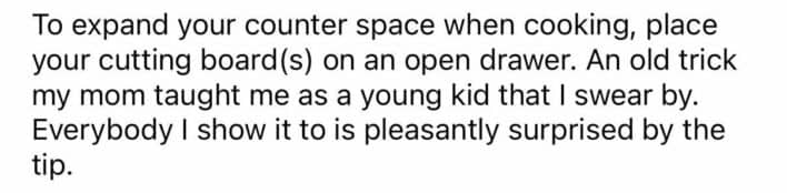 Placing cutting boards on open kitchen drawers instantly expands counter space while cooking